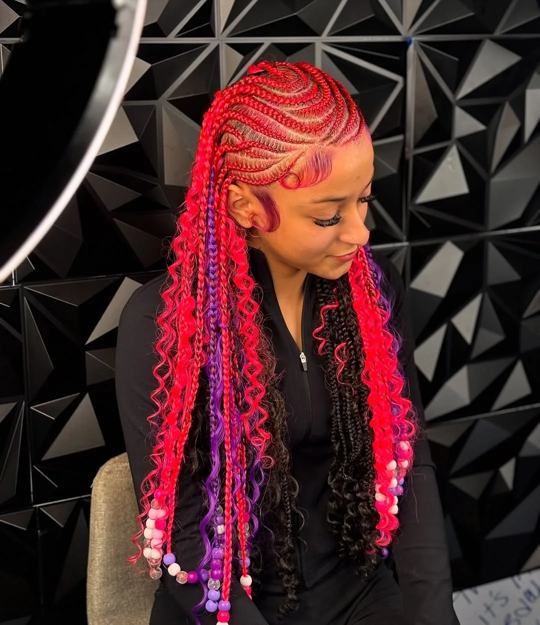 Close-up of a woman with beautiful summer braids ideas featuring intricate cornrows and flowing bohemian waves. Perfect for a chic beach vacation.