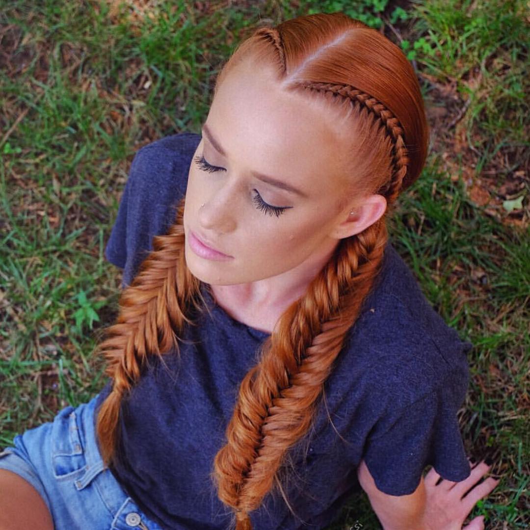 Close-up of a woman with long, dark hair styled in intricate box braids, perfect for summer braids ideas 2026. Her braids are neatly parted, showcasing diverse styling potential.