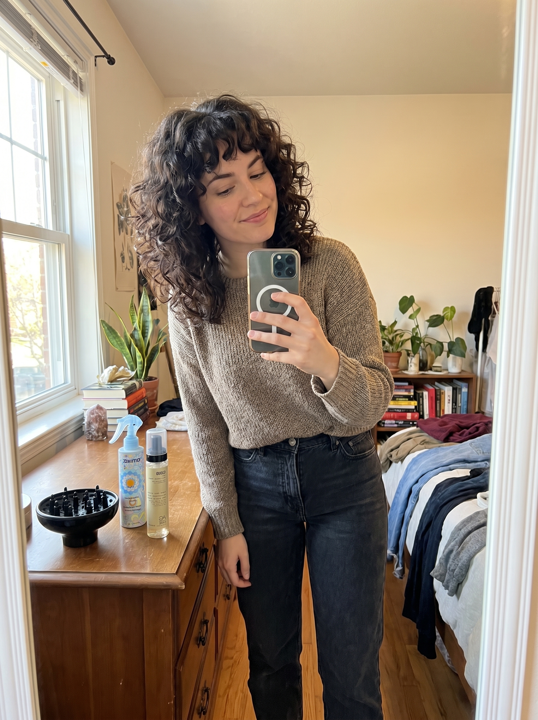 Playful Cloud Curls with Micro-Bangs in natural hair color and Apricot Crush, a voluminous style for summer curly hairstyles 2026.