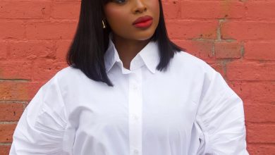 Beautiful black woman smiling, showcasing a chic, braided updo, perfect for summer. This elegant hairstyle is ideal for summer hairstyles for black women 2026.