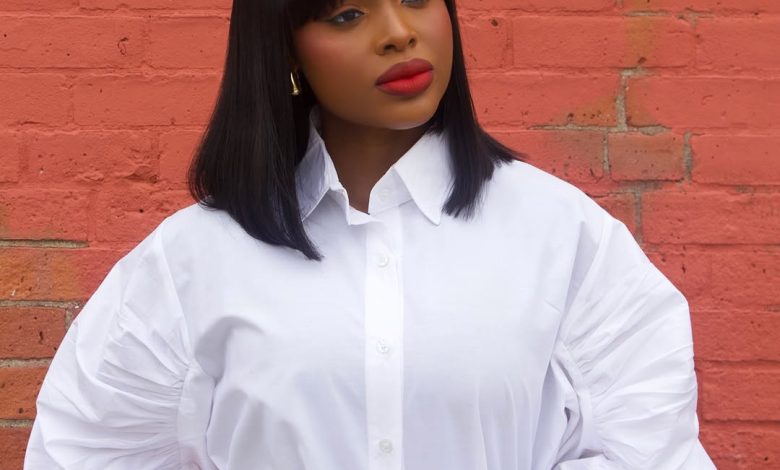 Beautiful black woman smiling, showcasing a chic, braided updo, perfect for summer. This elegant hairstyle is ideal for summer hairstyles for black women 2026.