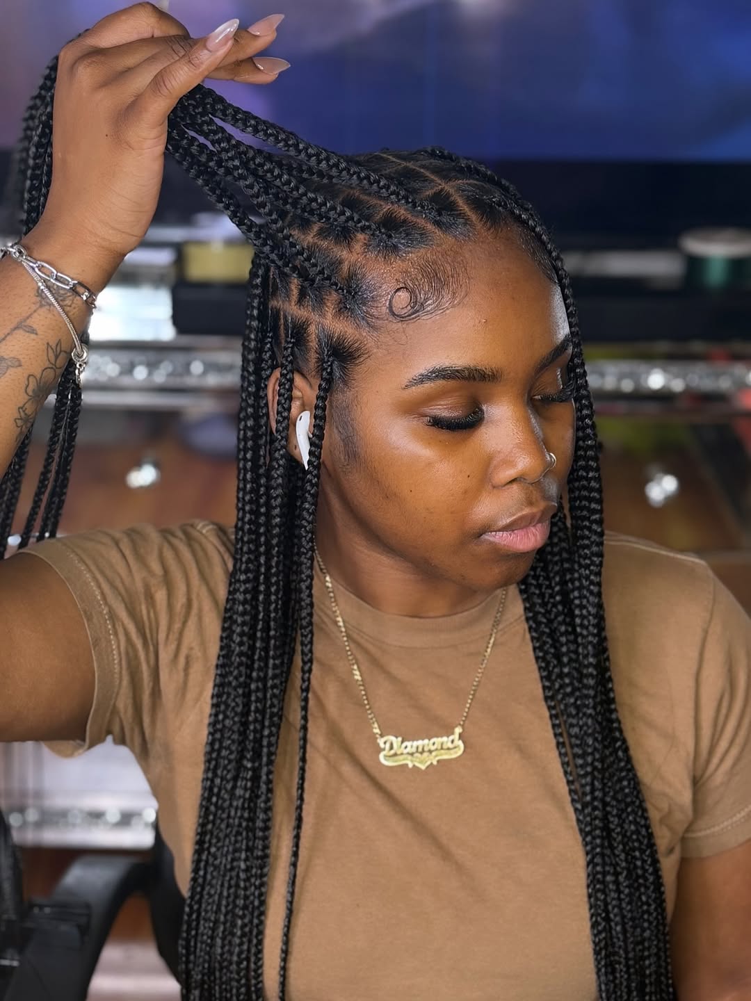 Beautiful black woman wearing a stylish, neat bun with intricate cornrows in the front, perfect for summer hairstyles for black women 2026. The updo is elegant and functional.