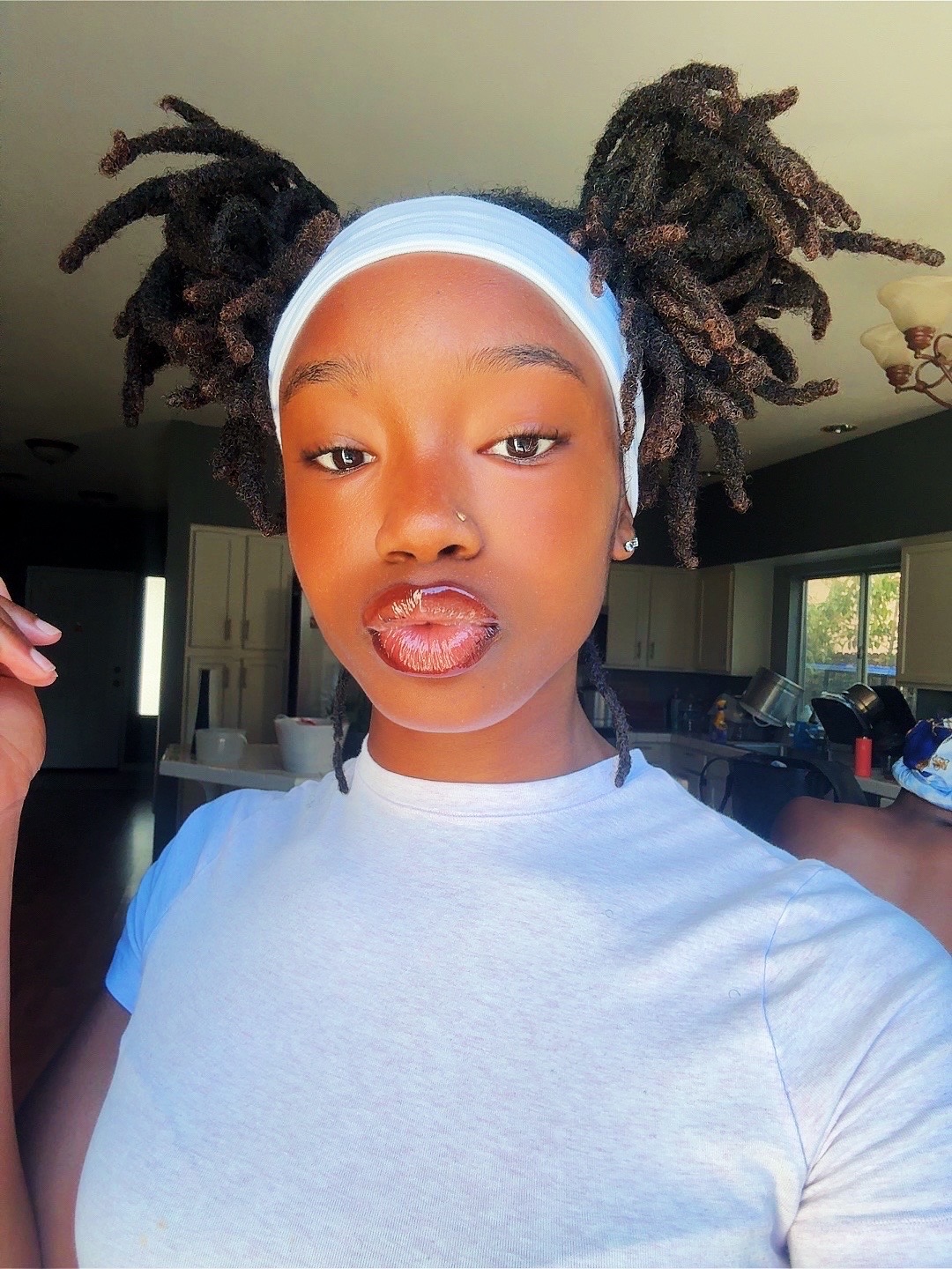 Close-up of a Black woman with a chic, braided updo, showcasing elegant summer hairstyles for black women 2026, perfect for a casual day out.