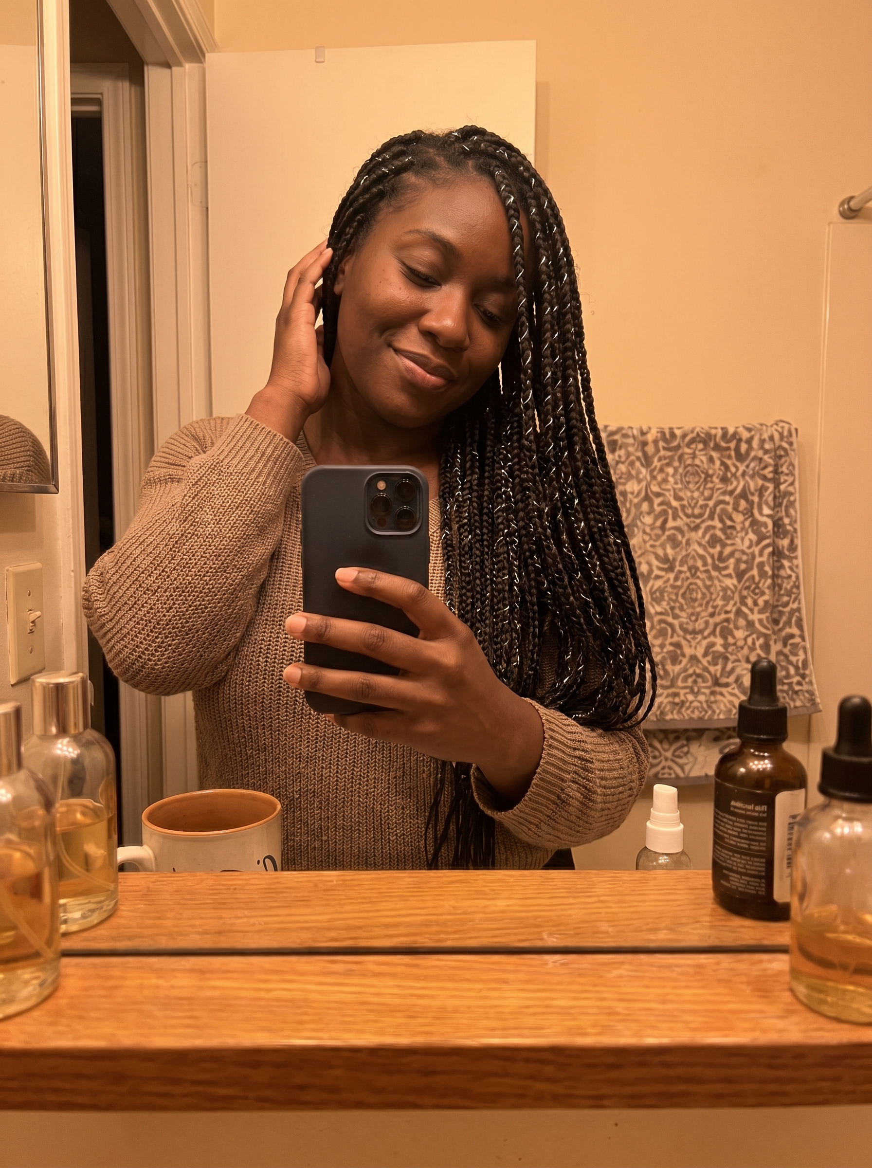 Edgy hydro-gloss stitch braids with sleek cyber-silver accents, an Afro-Futurism inspired look for summer hairstyles for black women 2026. Features extreme sleekness and a glossy finish.