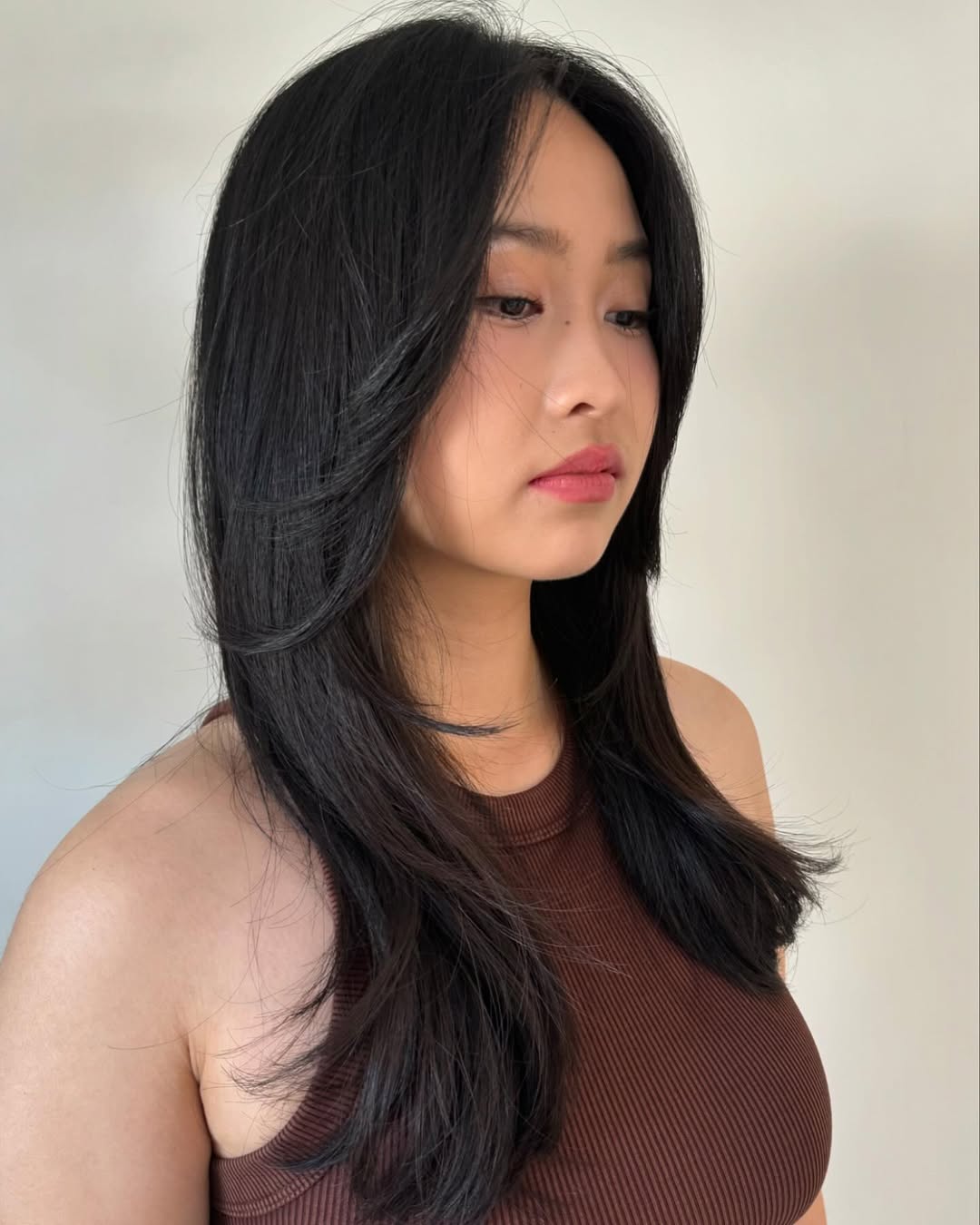 A woman with a sophisticated half-up bun, showcasing a chic option for summer hairstyles for medium hair. Her blonde hair is pulled back, highlighting a stylish and easy look perfect for warm weather.