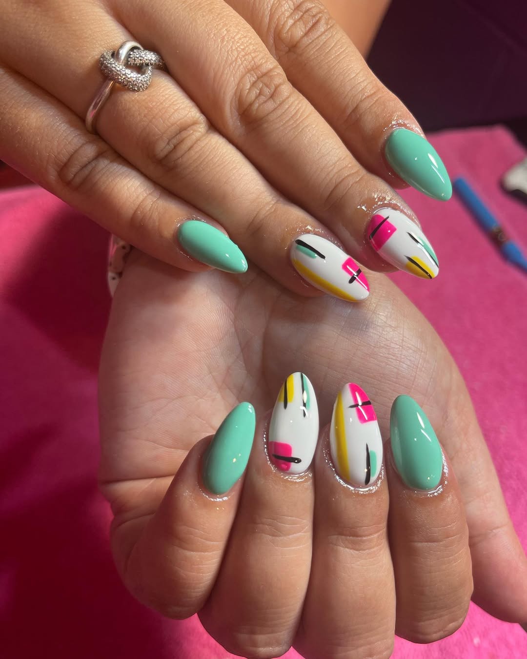 Vibrant Abstract Teal and White Almond Nails