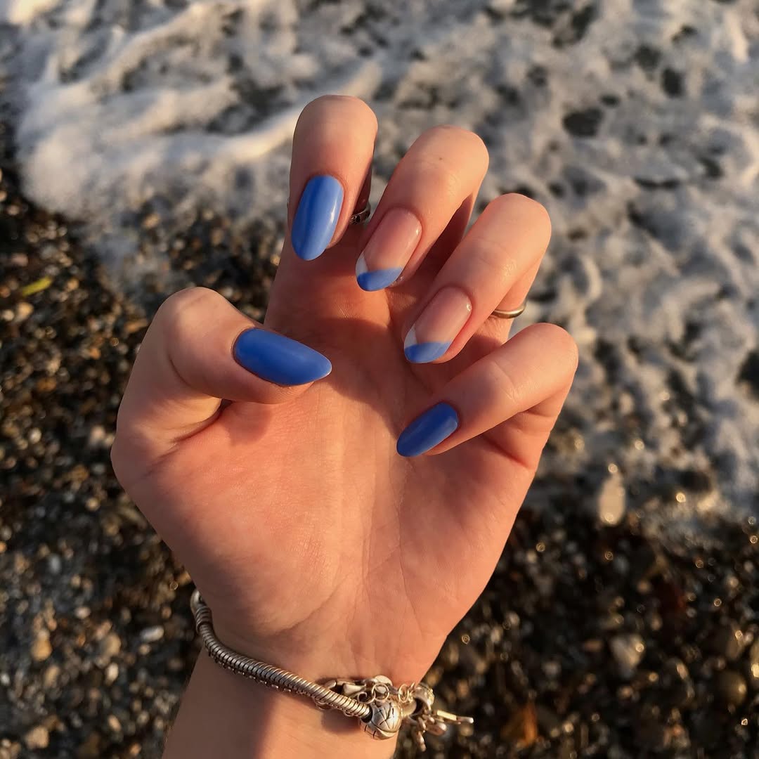 Vibrant Blue French Tips on Clear Oval Nails