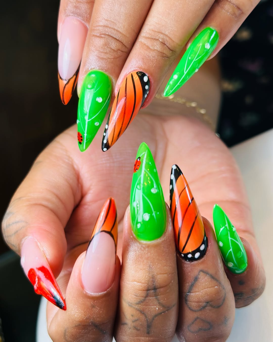 Vibrant Butterfly and Ladybug Almond Nail Art