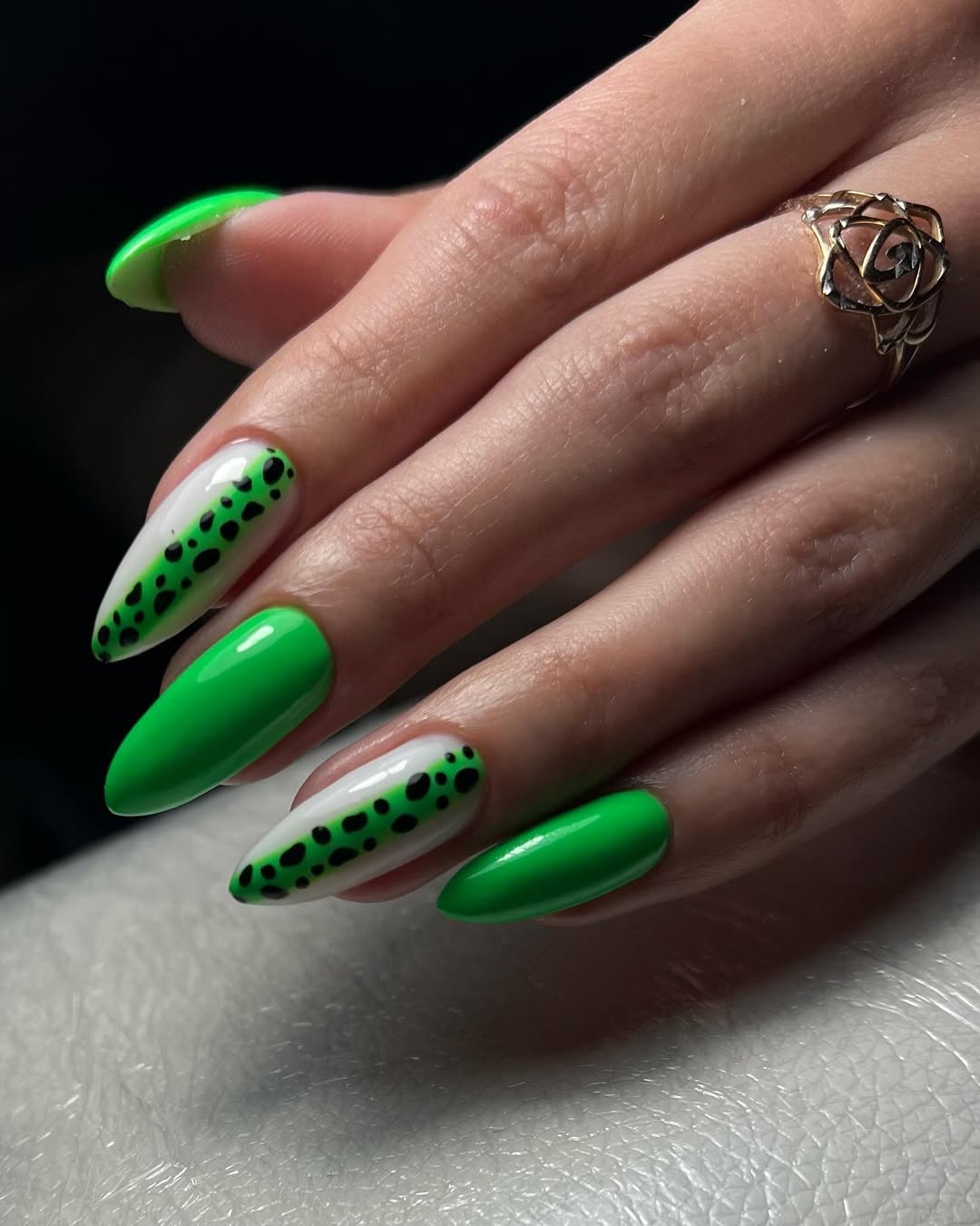 Vibrant Green Glossy Almond Nails with Dalmatian Accent