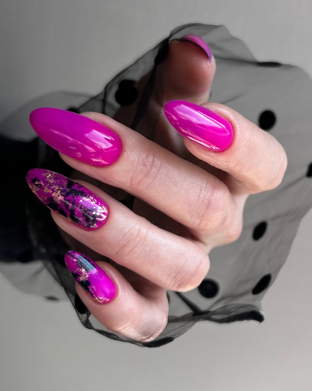 Vibrant Magenta Almond Nails with Black Gold Foil Accents