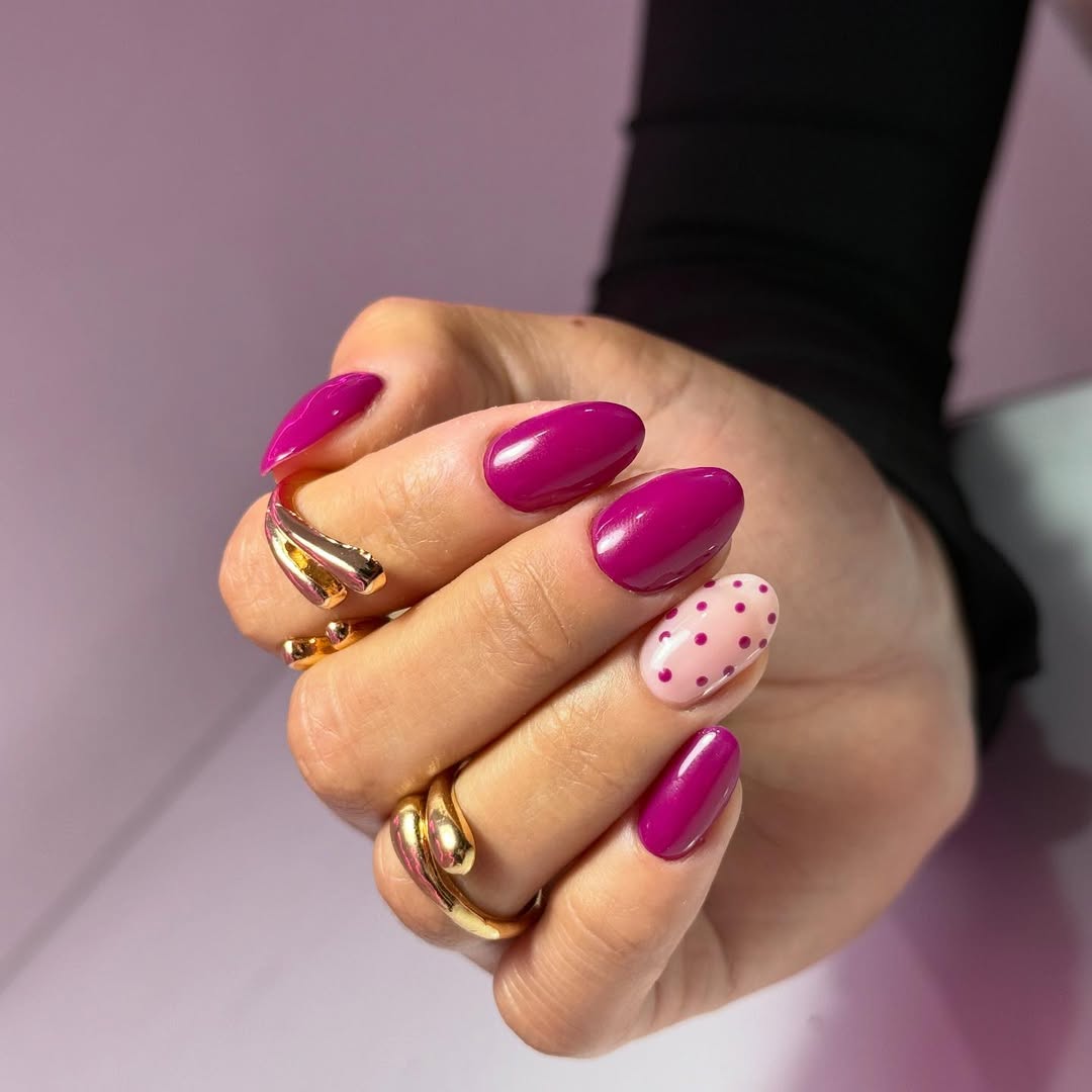 Vibrant Magenta Oval Nails with Polka Dot Accent