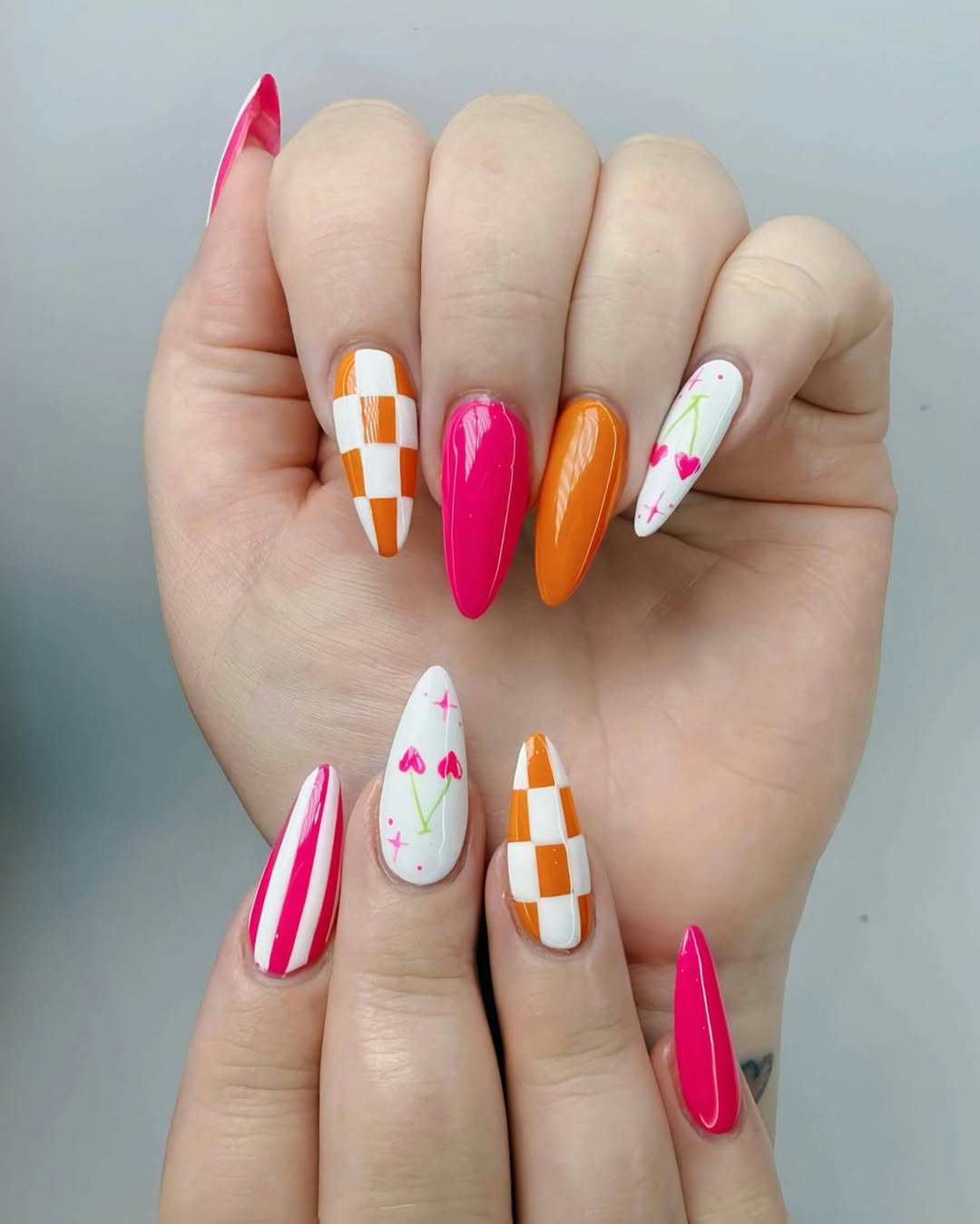 Vibrant Mix-and-Match Cherry Checkered and Striped Almond Nails