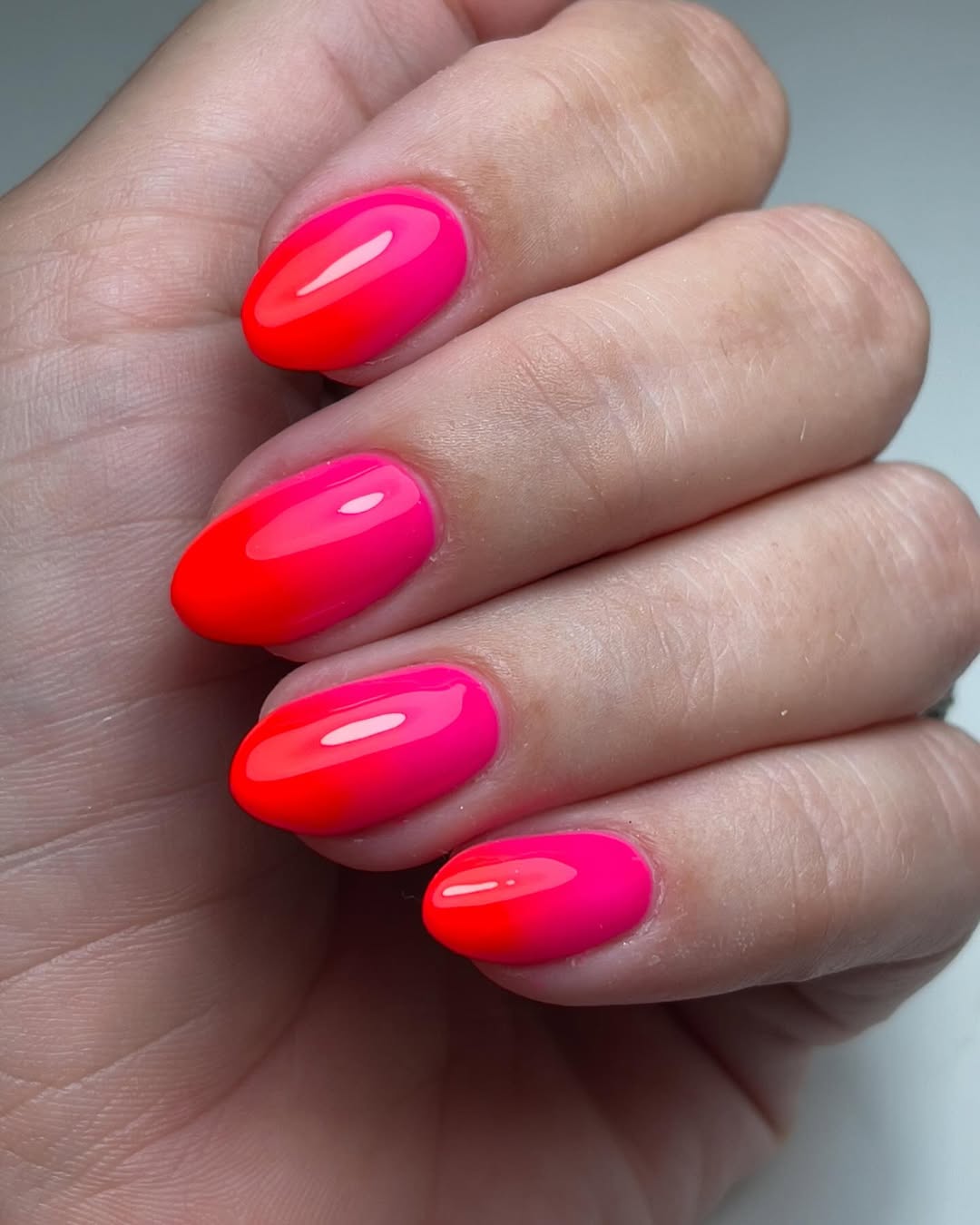 Vibrant Neon Pink and Orange Glossy Ombre Oval Nails