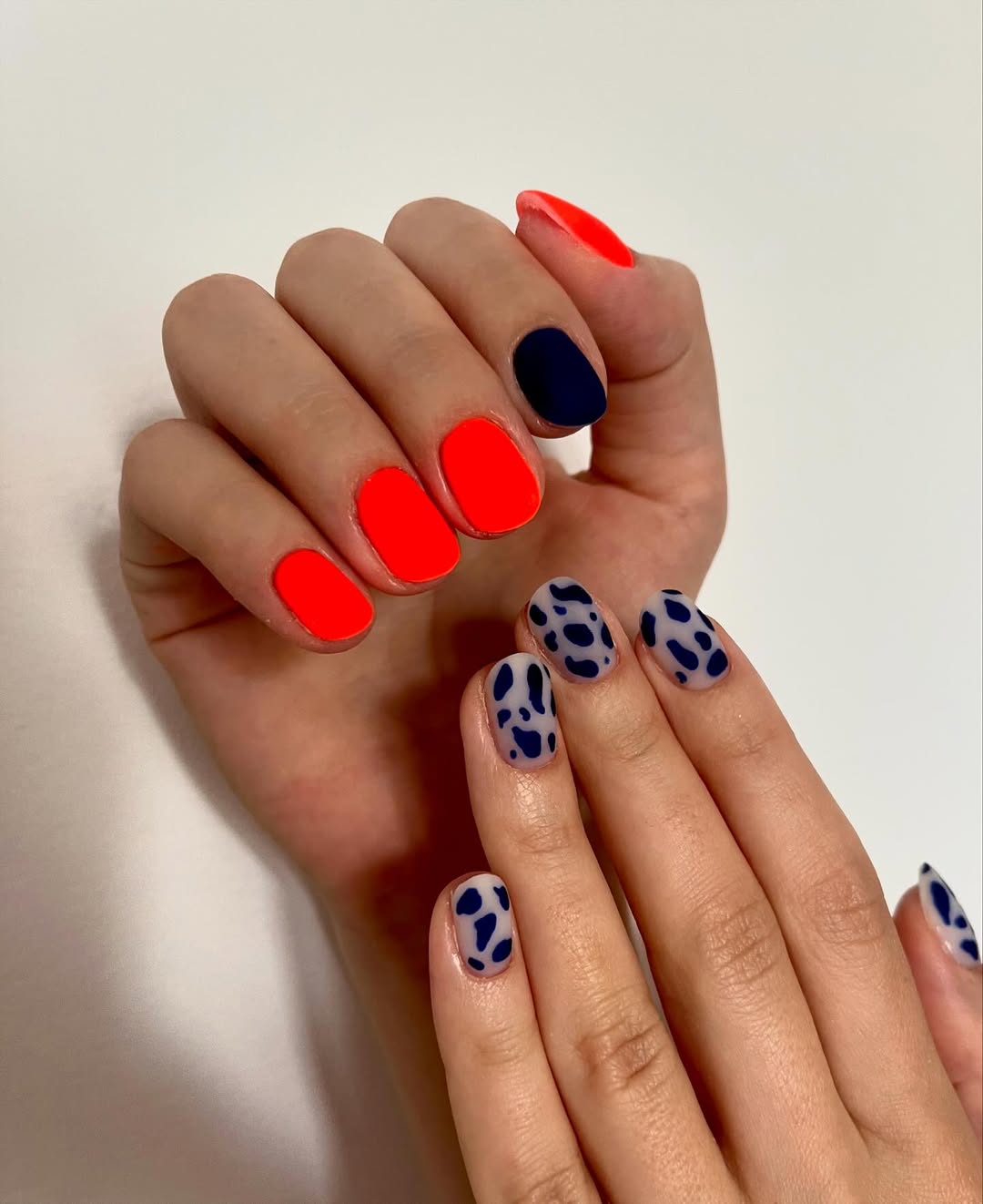 Vibrant Orange and Cow Print Mismatched Matte Nails