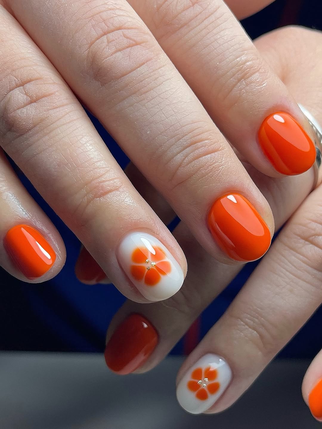 Vibrant Orange and White Floral Accent Nails