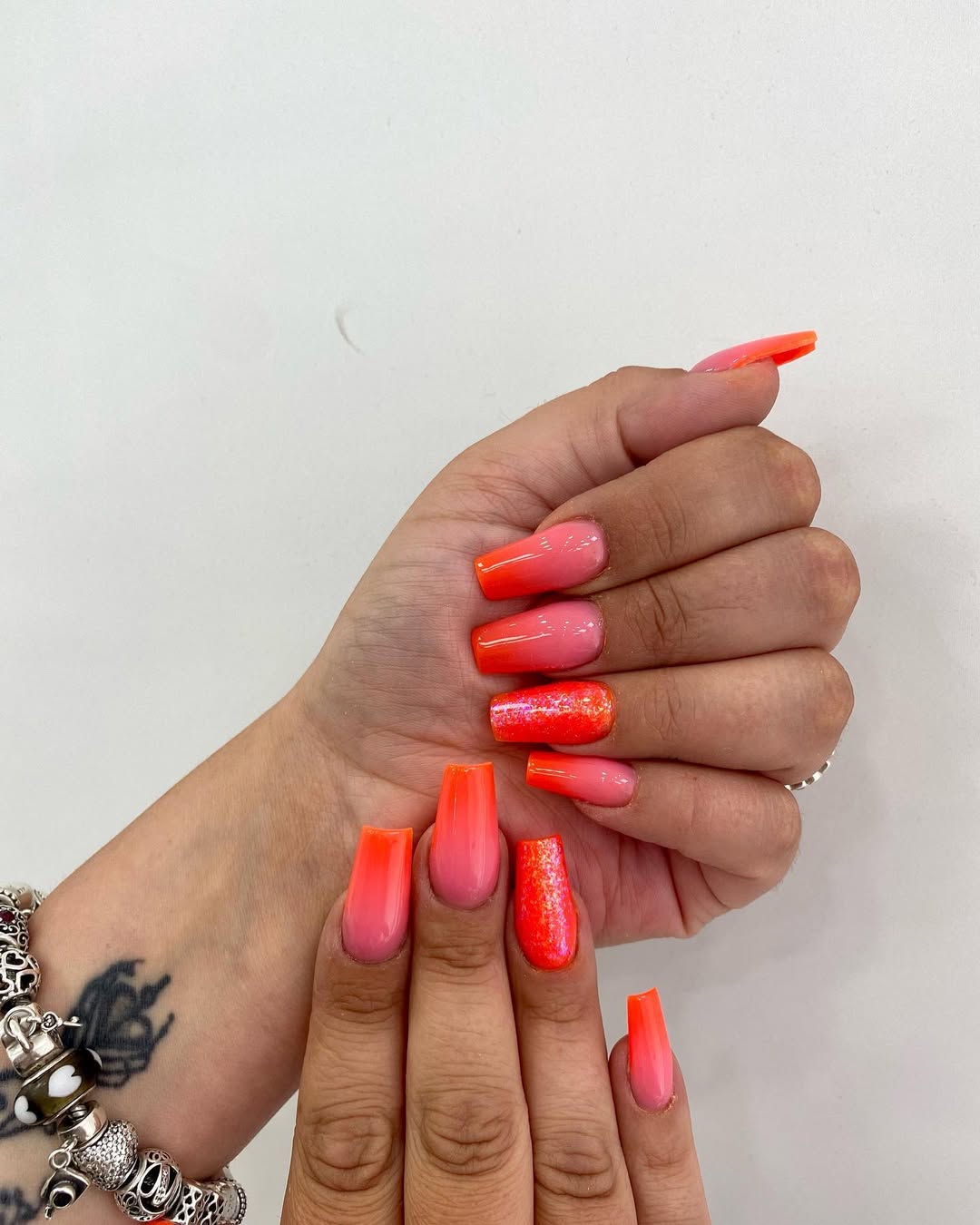 Vibrant Orange Pink Ombré Coffin Nails with Glitter
