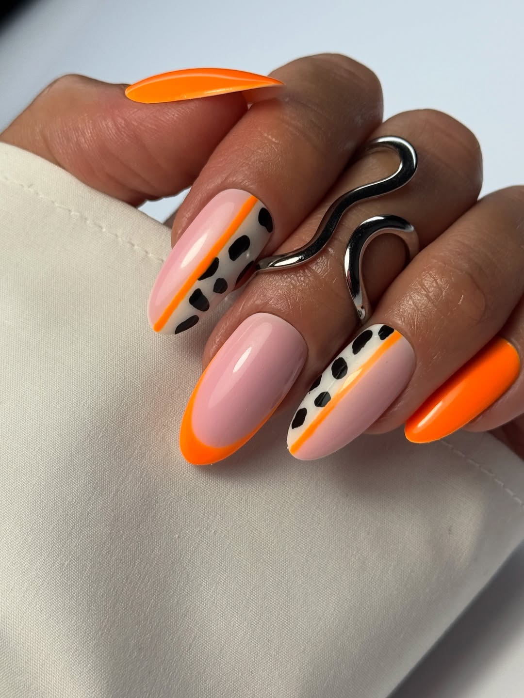 Vibrant Orange Tips And Abstract Animal Print Oval Nails