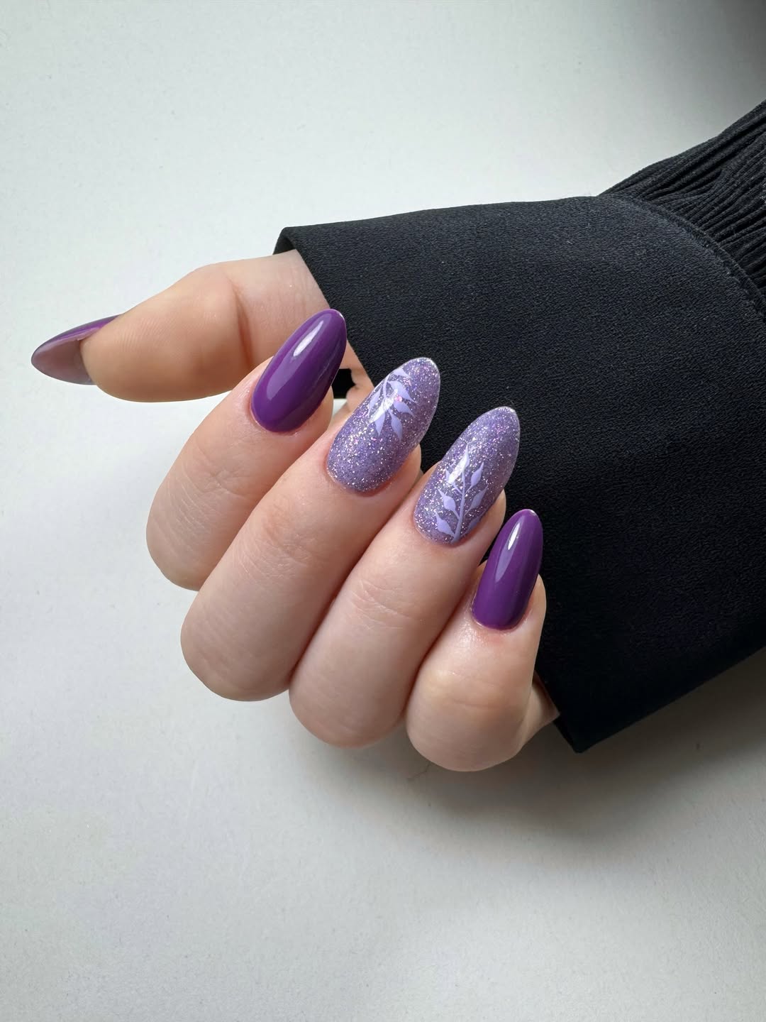 Vibrant Purple and Shimmer Almond Nails with Leaf Art