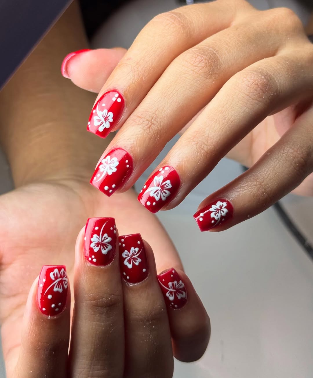 Vibrant Red Gel Nails with White Floral Art