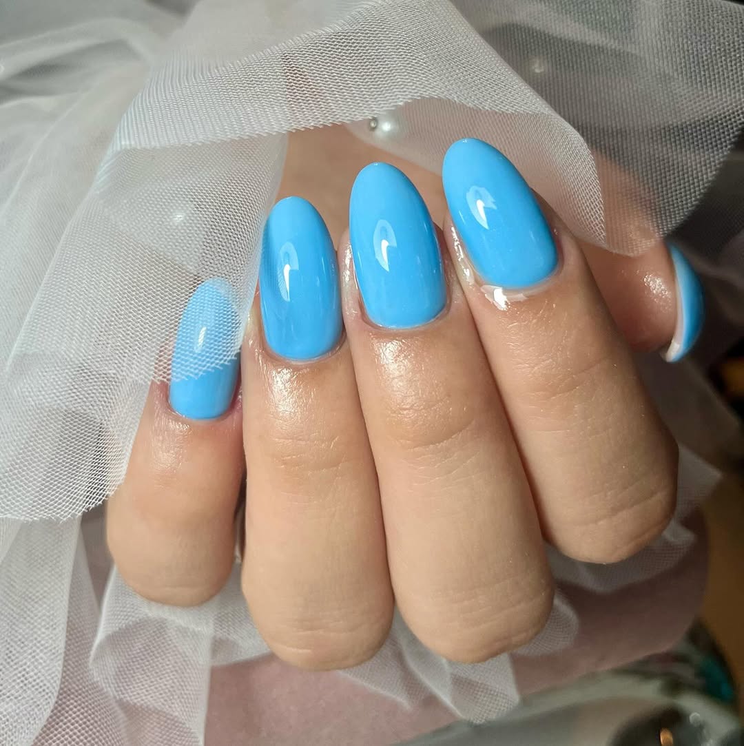 Vibrant Sky Blue Glossy Oval Nails with Net Accent