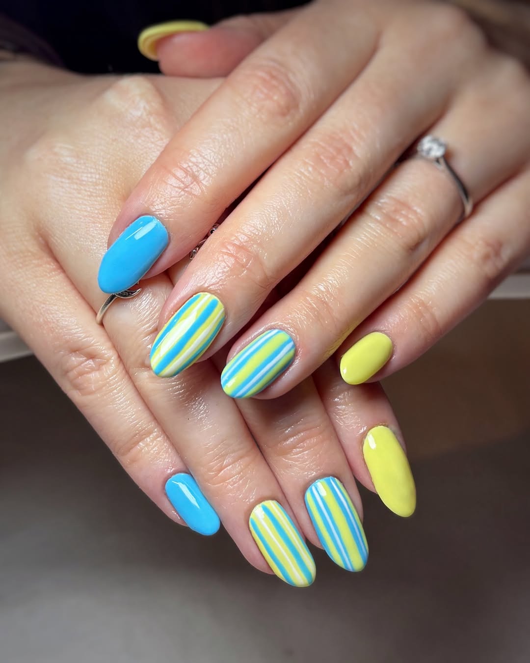 Vibrant Yellow and Blue Striped Almond Nails