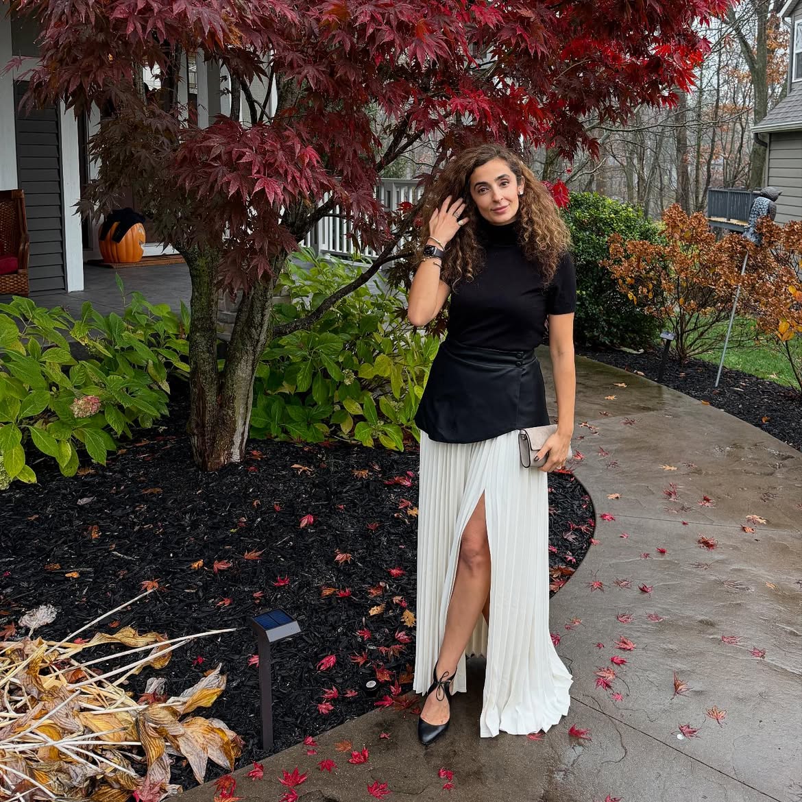 Black Turtleneck With Pleated Skirt And Leather Overlay