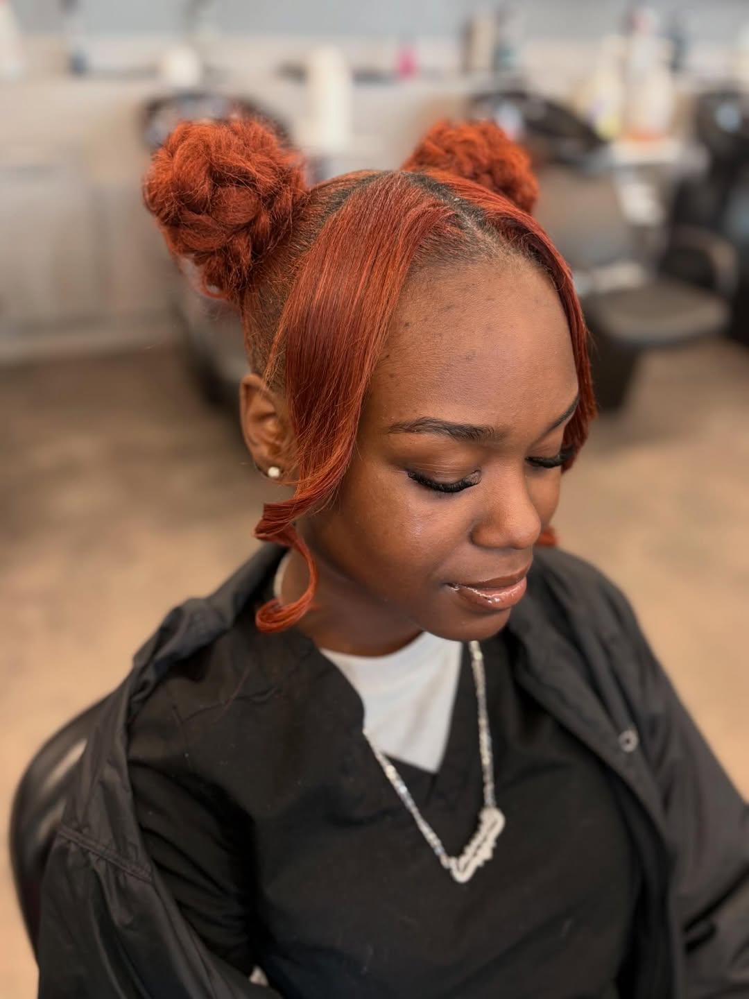 Bold Auburn Space Buns With Face-Framing Bangs