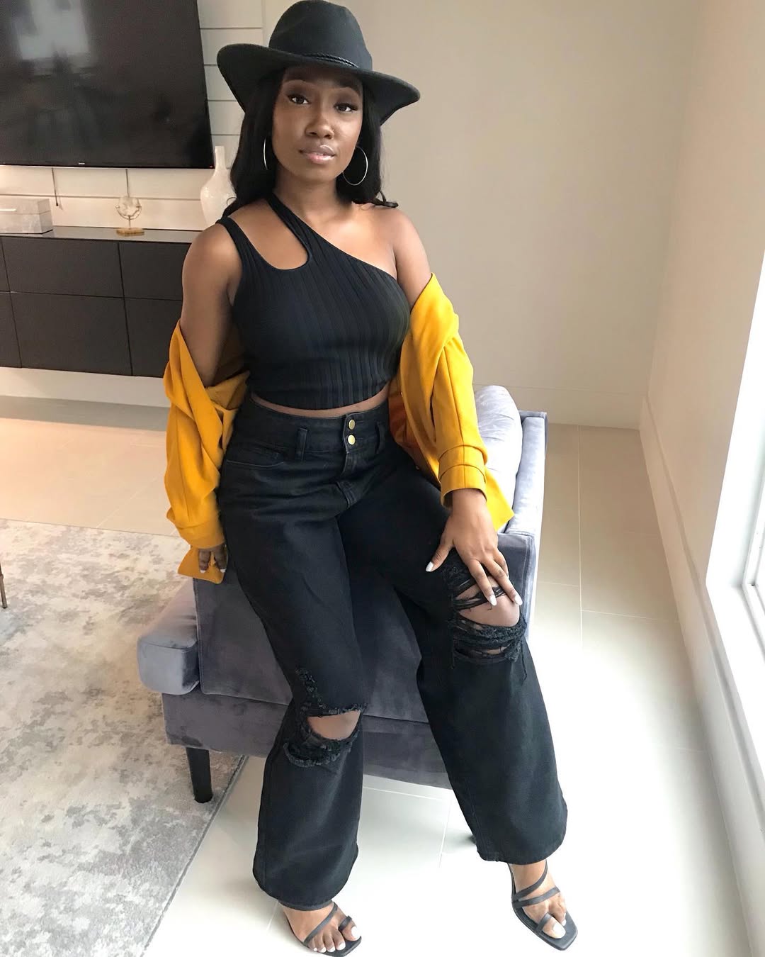 Bold Contrast Yellow Jacket With Ripped Black Jeans