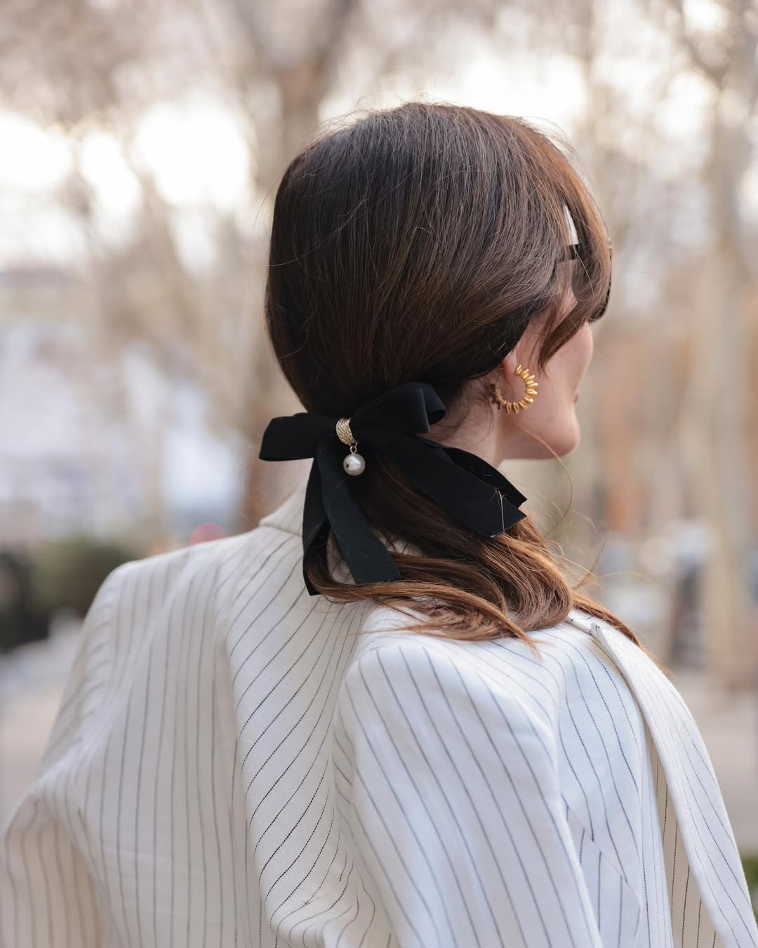 Deep Brunette Low Ponytail With Black Bow