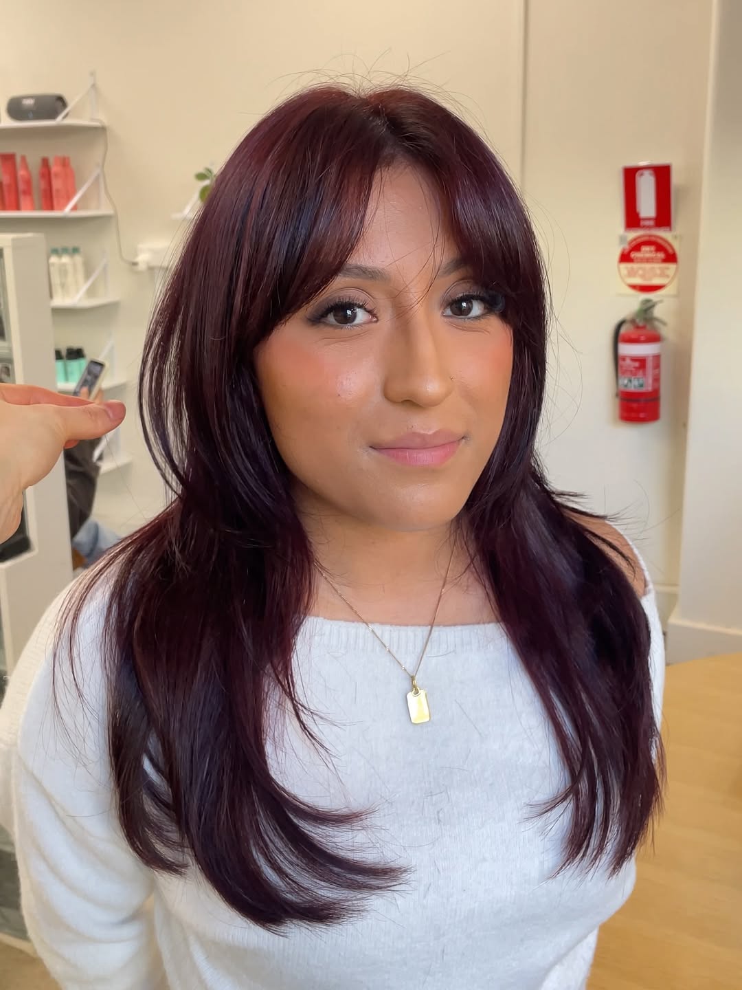Deep Burgundy Layers With Soft Face-Framing Bangs
