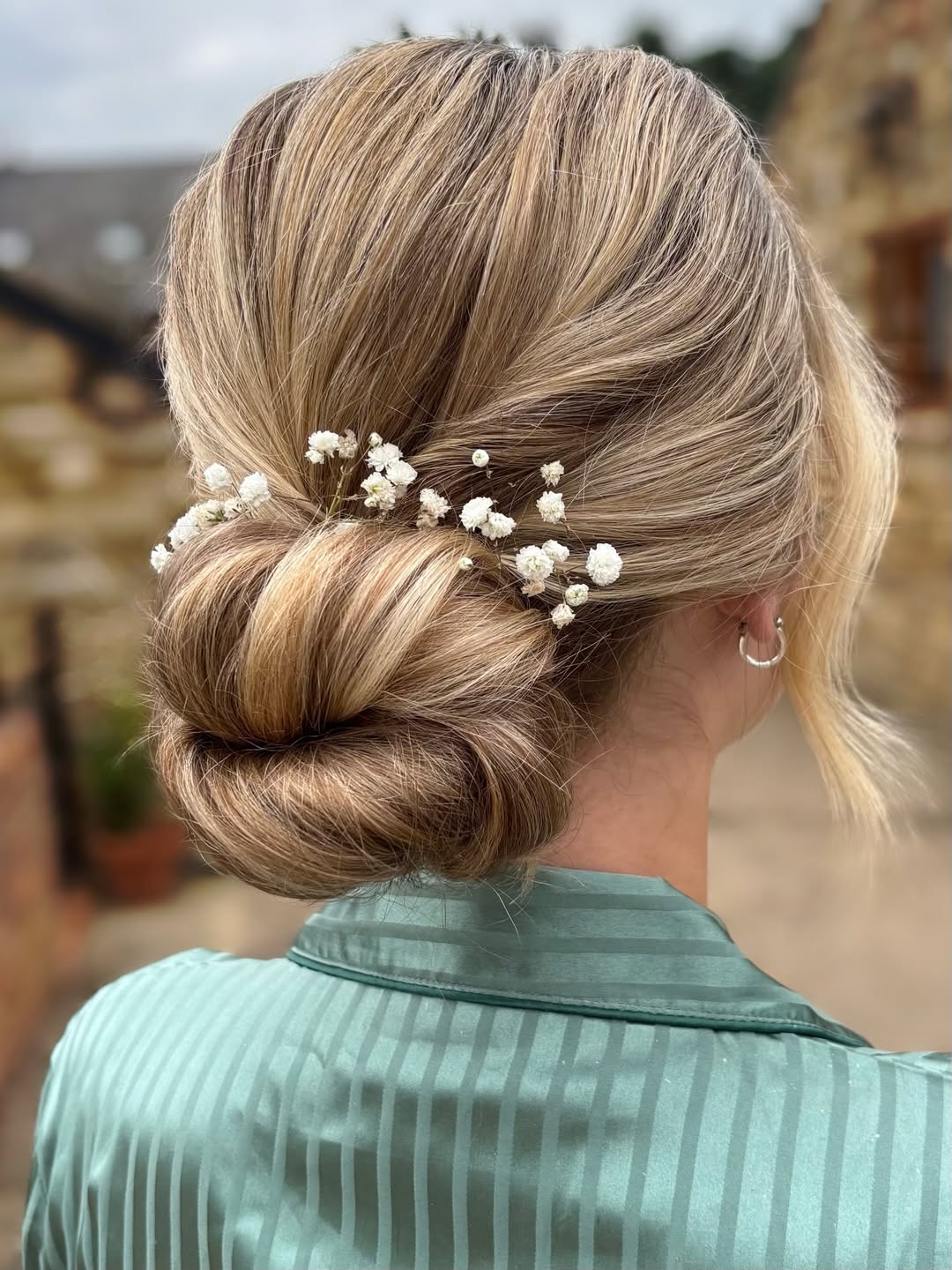 Elegant Low Bun With Delicate Floral Details