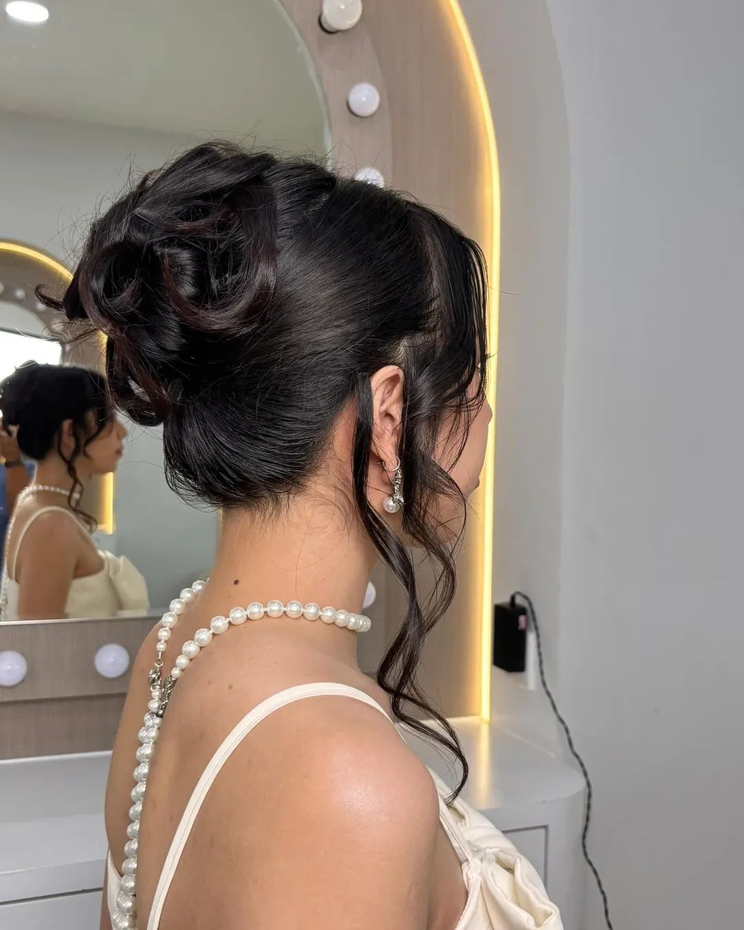 Elegant Sculpted Updo With Loose Tendrils