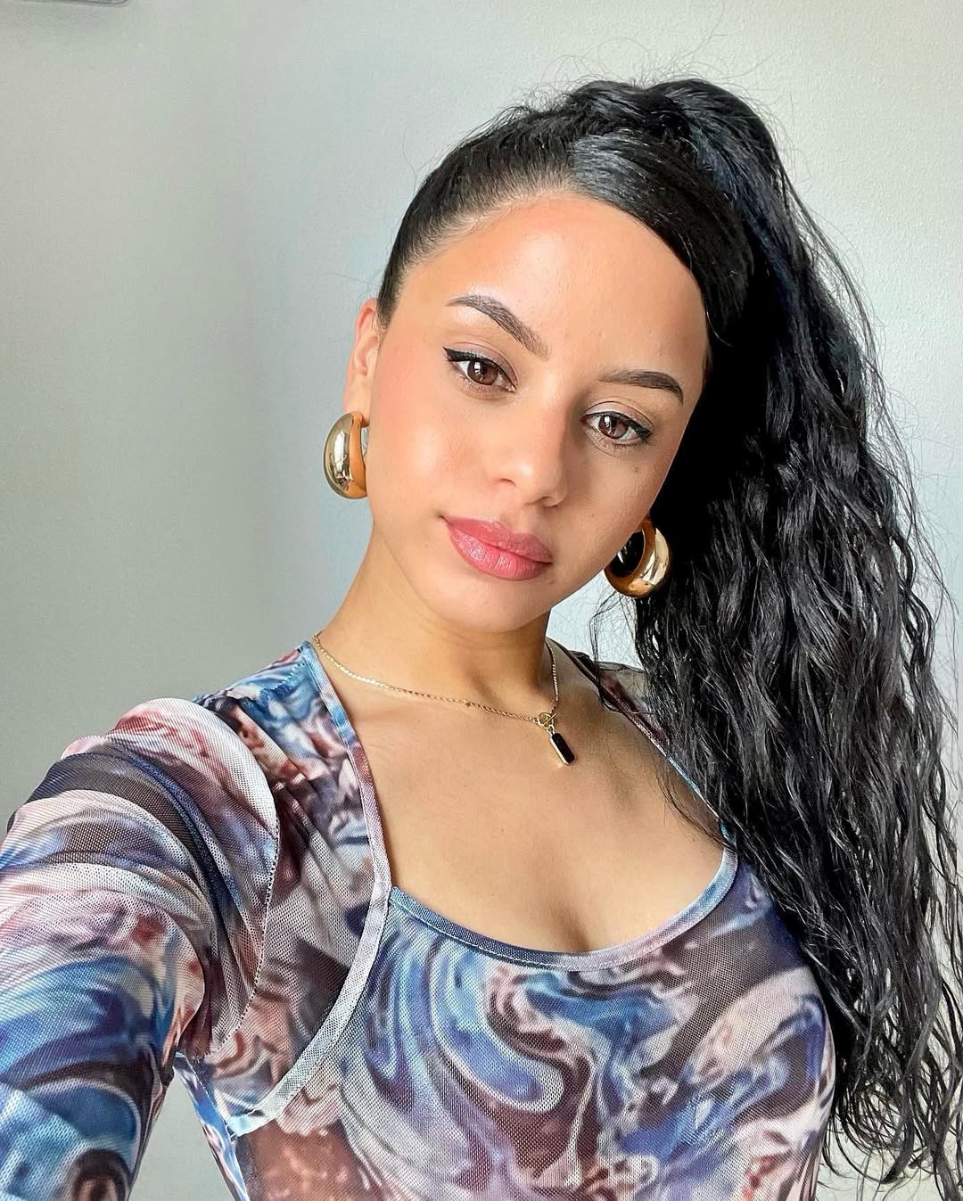 Glam High Ponytail With Defined Dark Curls