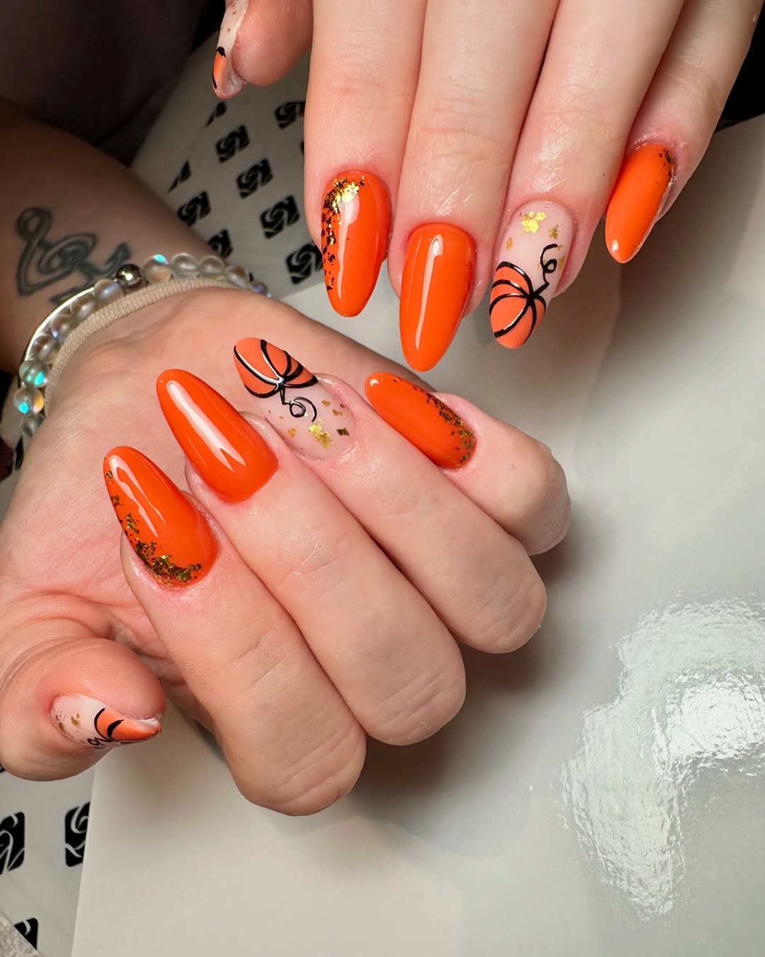 Glossy Pumpkin Orange Nails with Gold Flakes and Vines