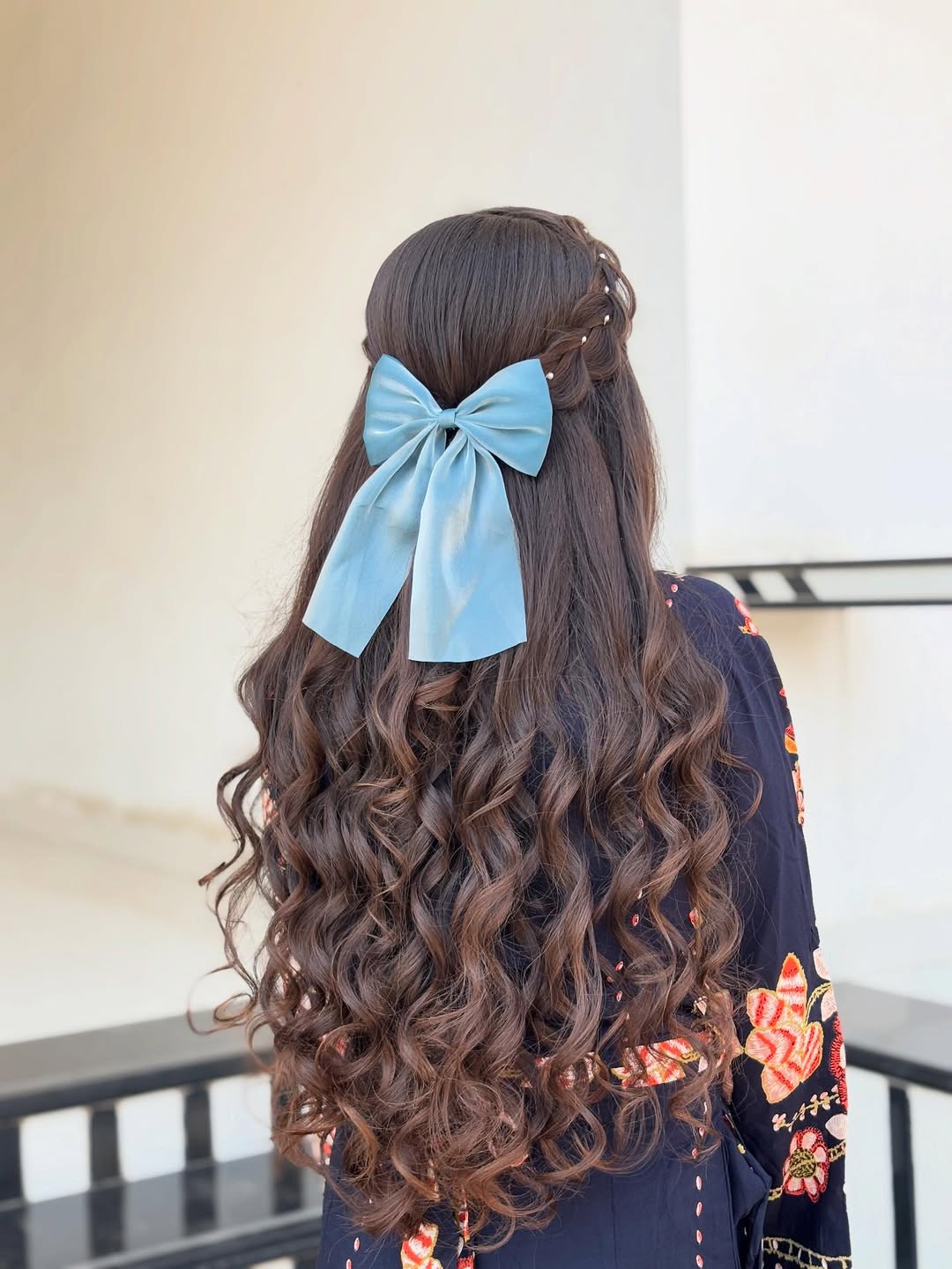Half Up Braids With Bow And Voluminous Curls