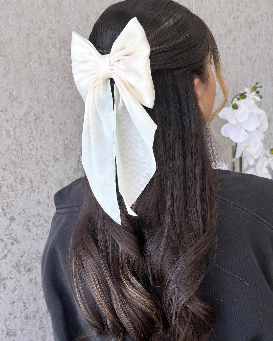Half-Up Brunette Waves With Elegant Cream Bow