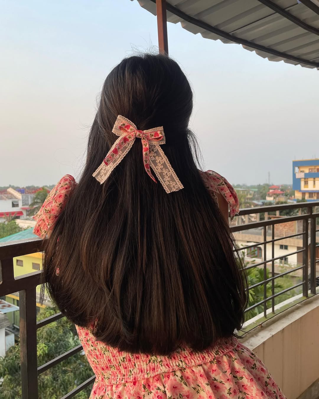 Half-Up Hairstyle With A Pastel Floral Bow