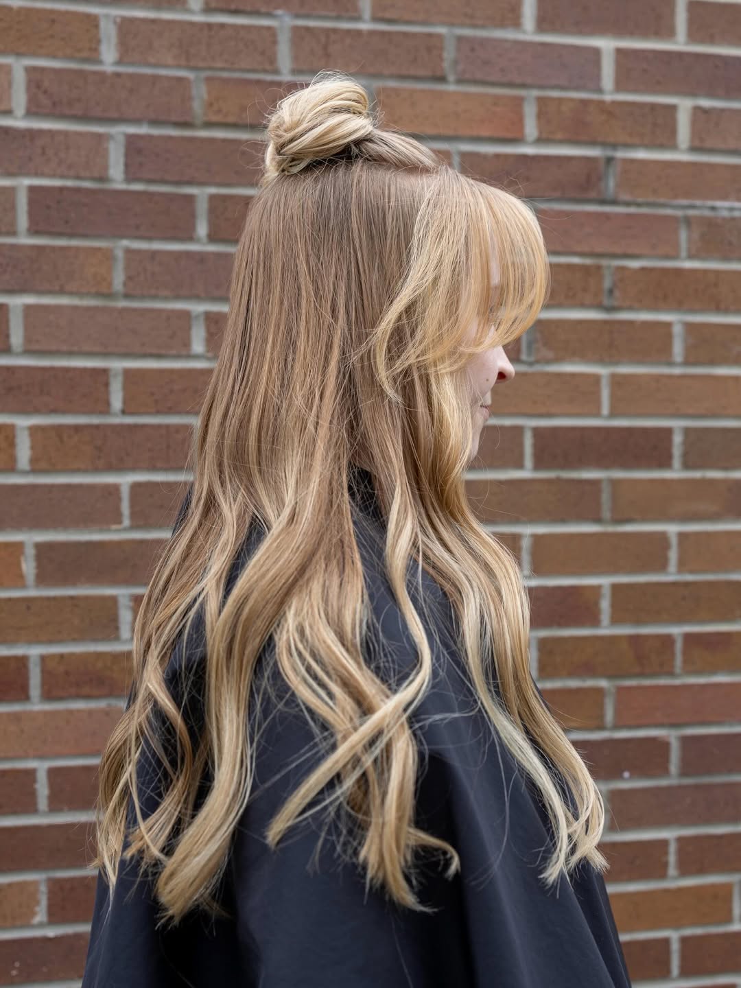 Half-Up Top Knot With Wavy Blonde Lengths