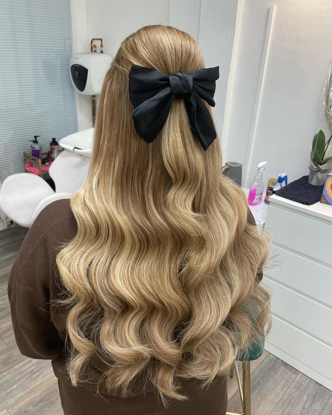 Half-Up Wavy Blonde Hair with Black Bow
