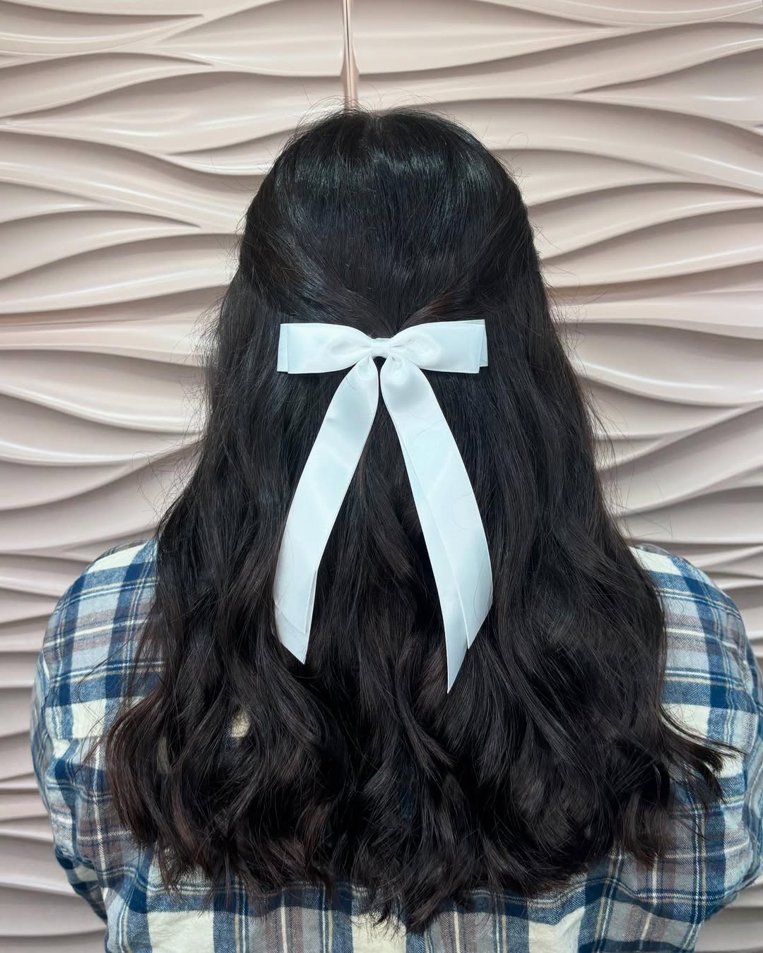 Half-Up Wavy Hair With White Bow Accent