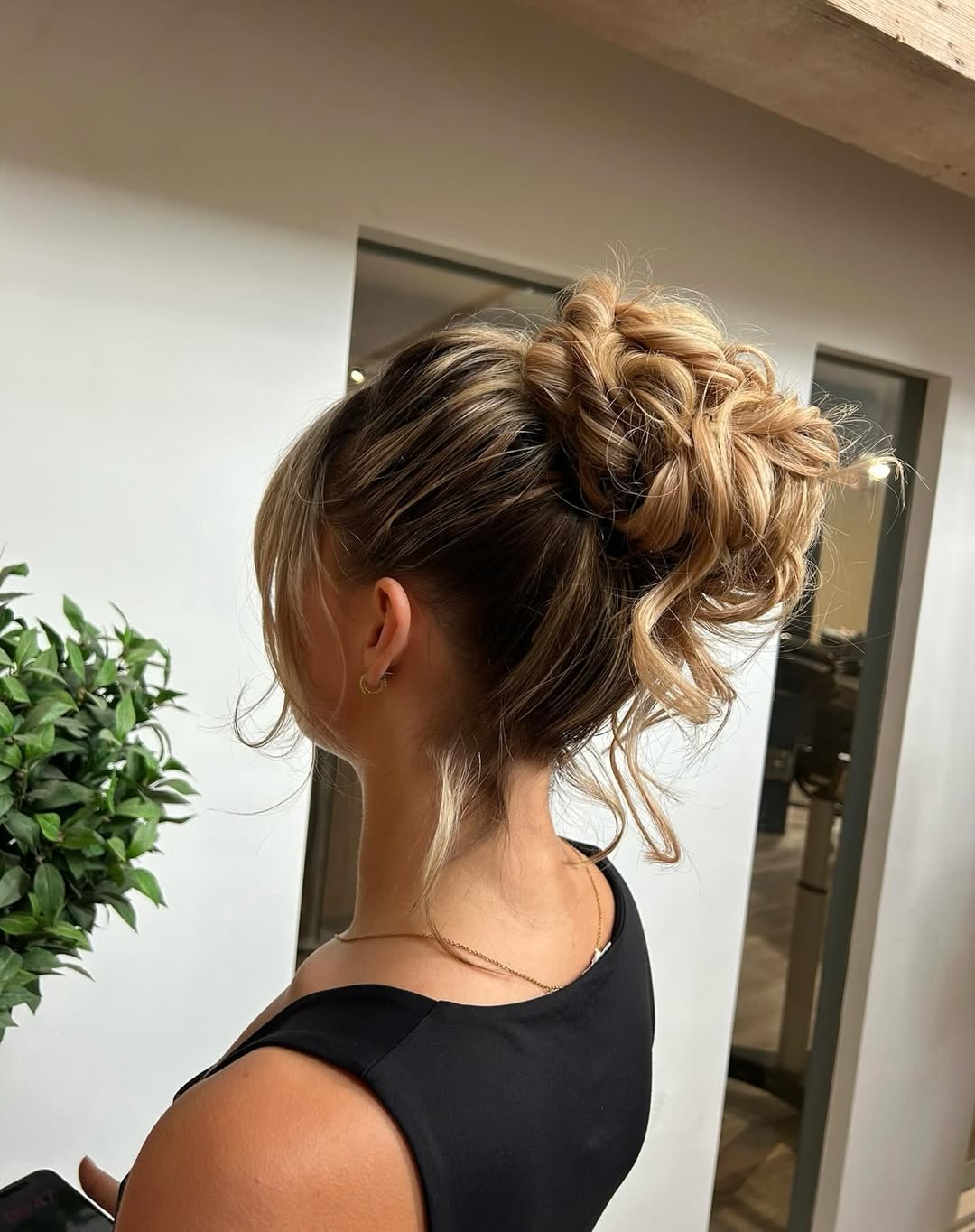 Messy Braided Bun With Face Framing Highlights