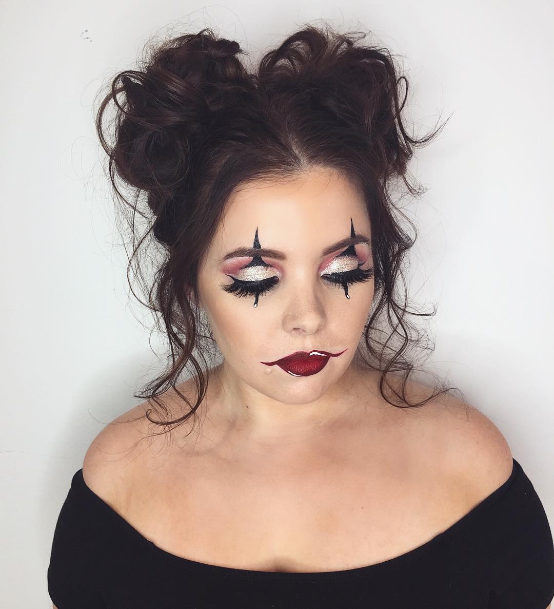 Messy Space Buns With Face-Framing Tendrils