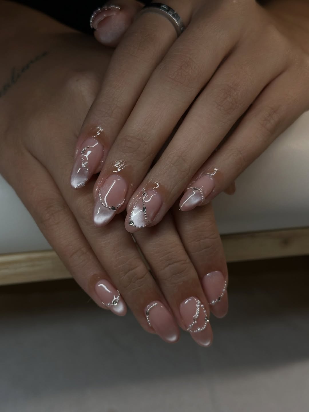 Milky Pink Cat Eye Chrome Almond Nails With Silver Accents