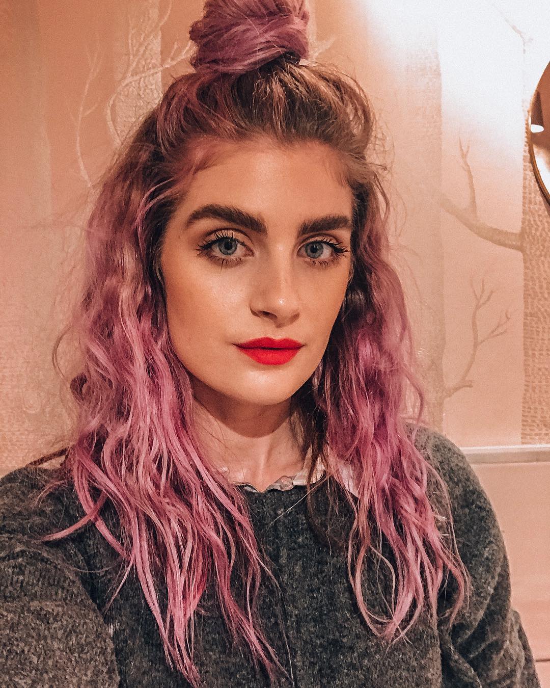 Pink Wavy Hair With Messy Top Knot