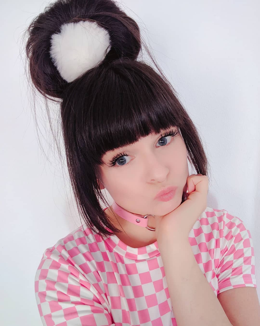 Playful Double Bun Hairstyle with Blunt Bangs