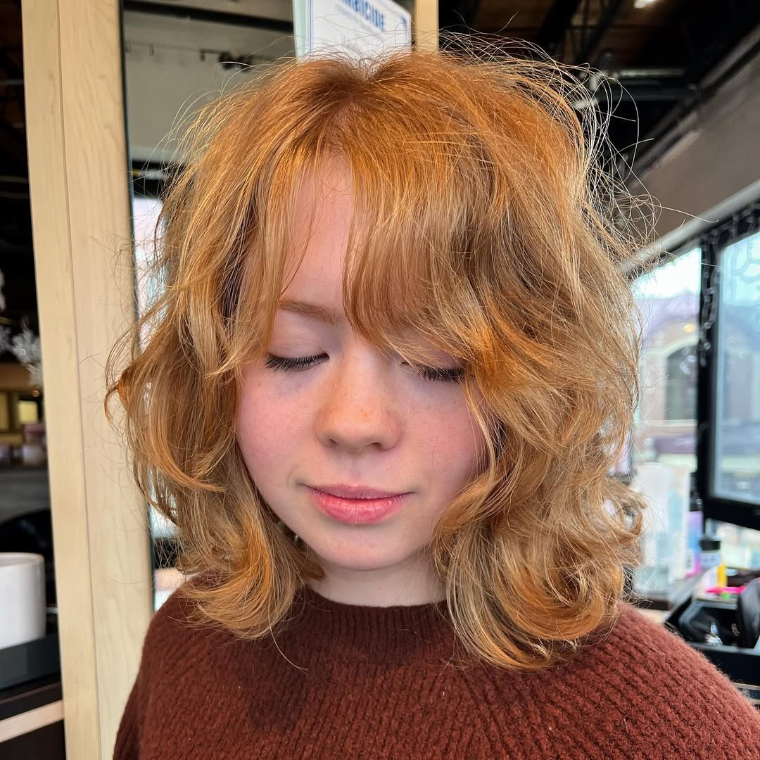 Shaggy Auburn Bob With Face-Framing Layers And Wispy Bangs