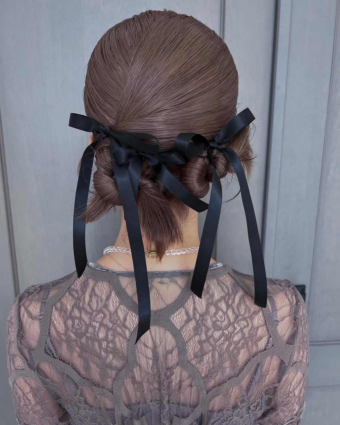 Sleek Double Low Buns With Black Ribbons