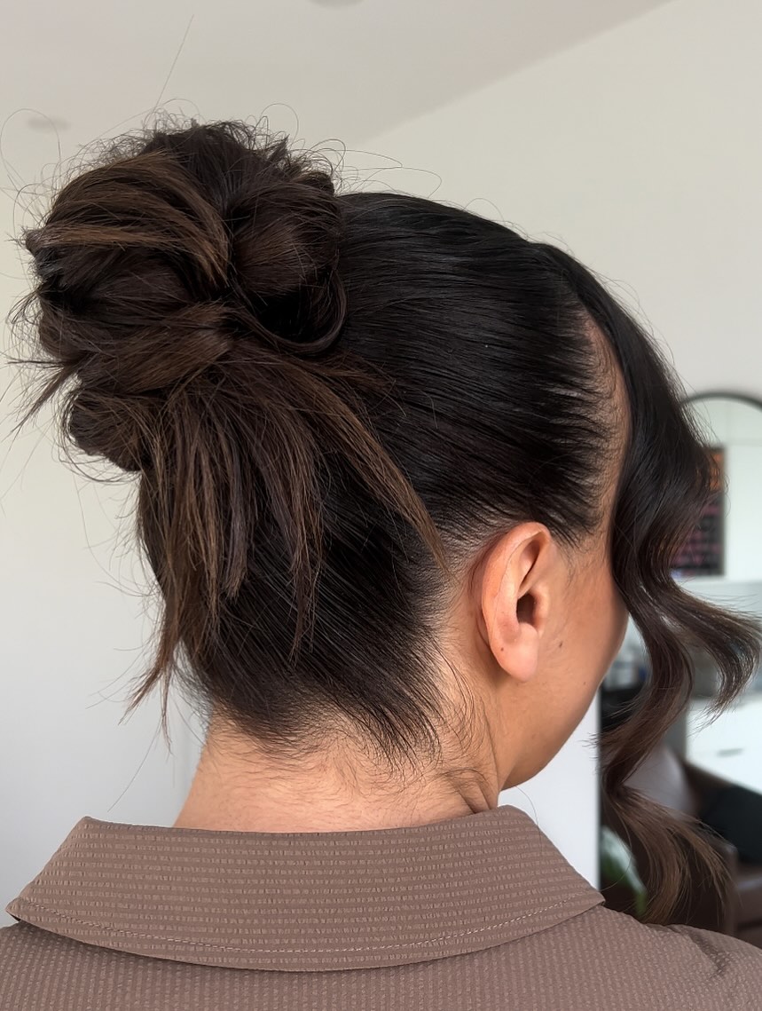 Sleek High Messy Bun With Wavy Face Frame