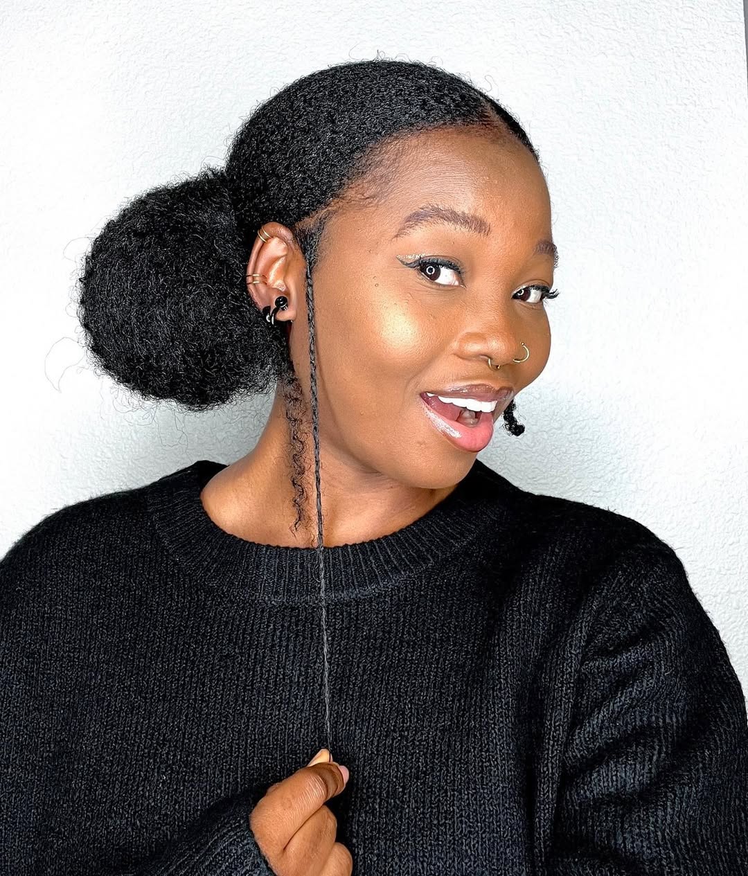 Sleek Low Bun With Curly Face-Framing Tendrils