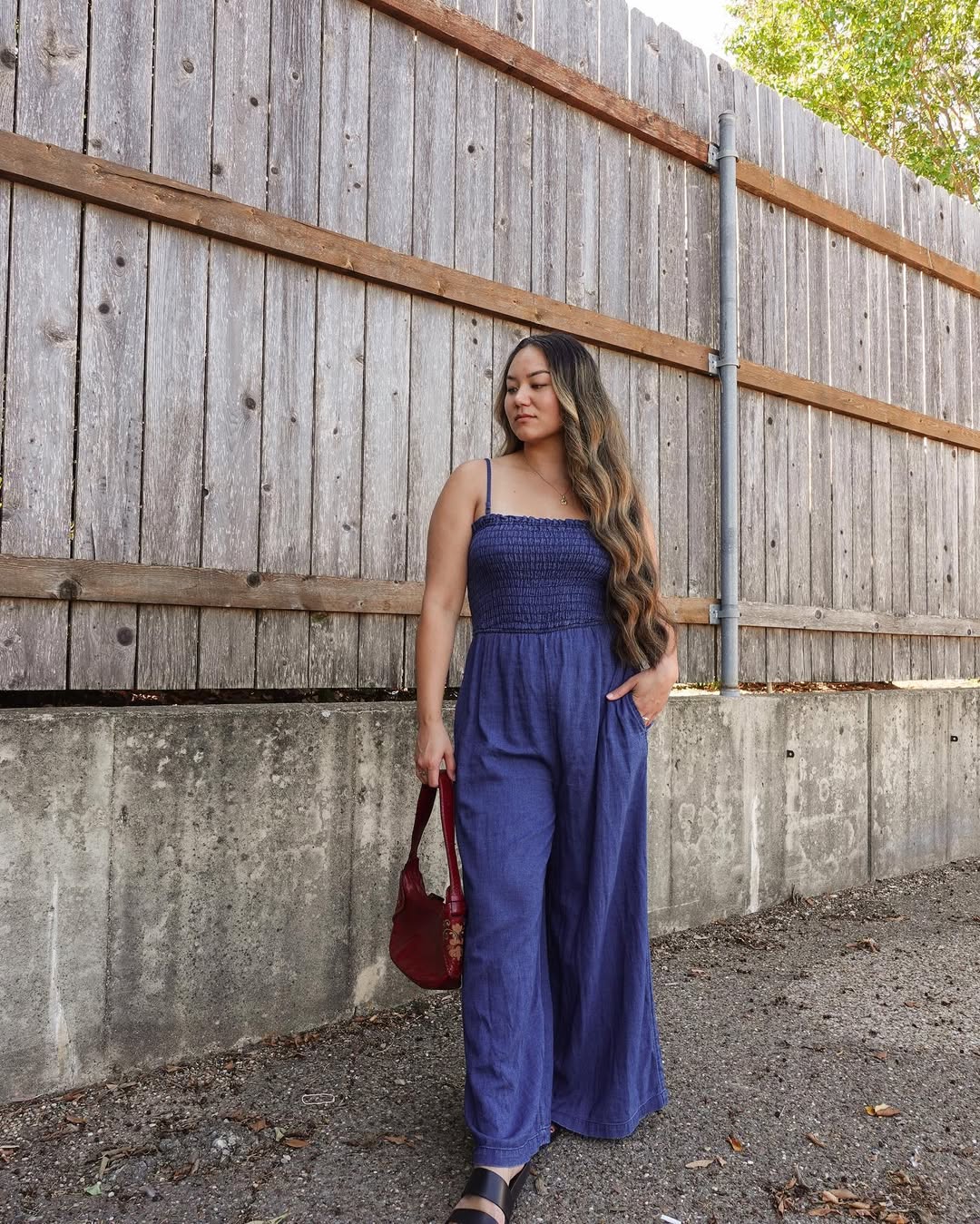 Smocked Bodice Wide Leg Jumpsuit With Red Shoulder Bag